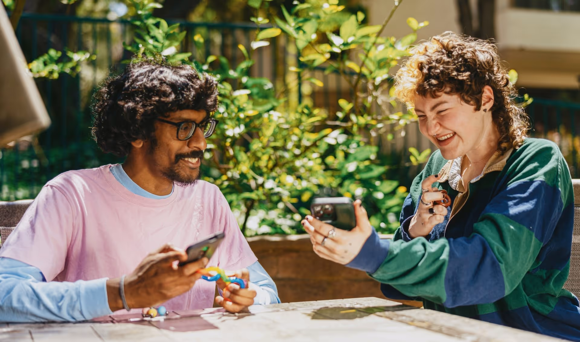 Two people sit outdoors